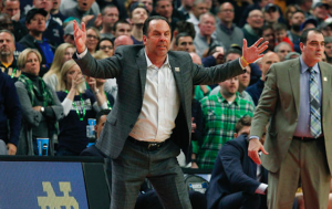 Mike Brey puts hands up