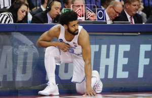 Joel Berry kneels at scorers table