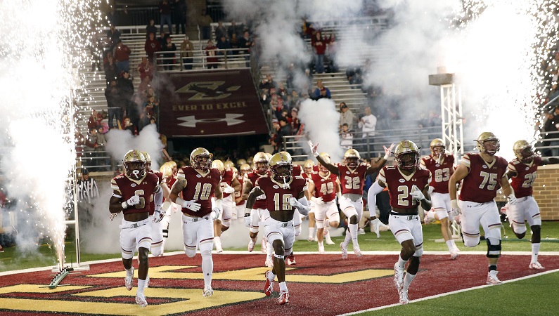 Boston College football team running on to field